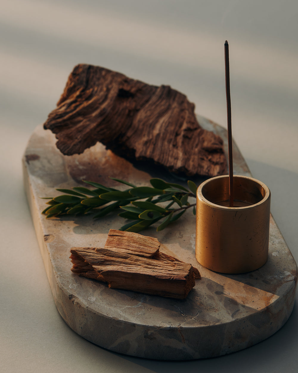 KIC Energise incense stick burning in a brass holder with sandalwood and botanicals