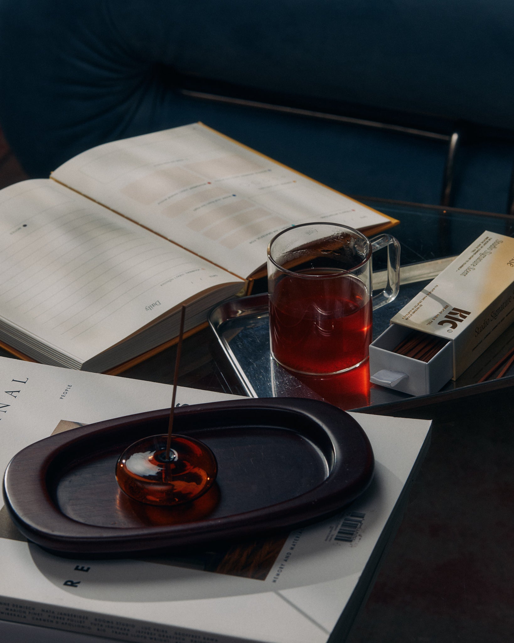 KIC herbal tea, incense and goals journal styled together on a coffee table
