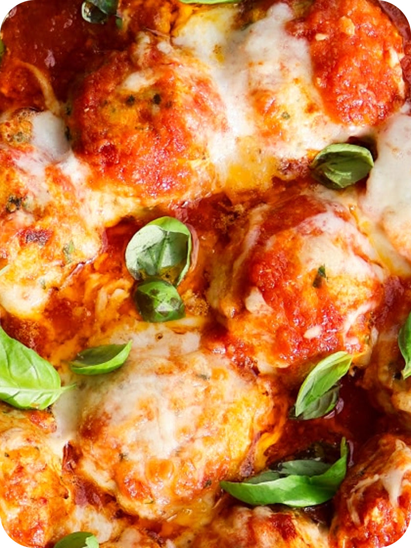 Close-up of a pizza with melted cheese and basil leaves