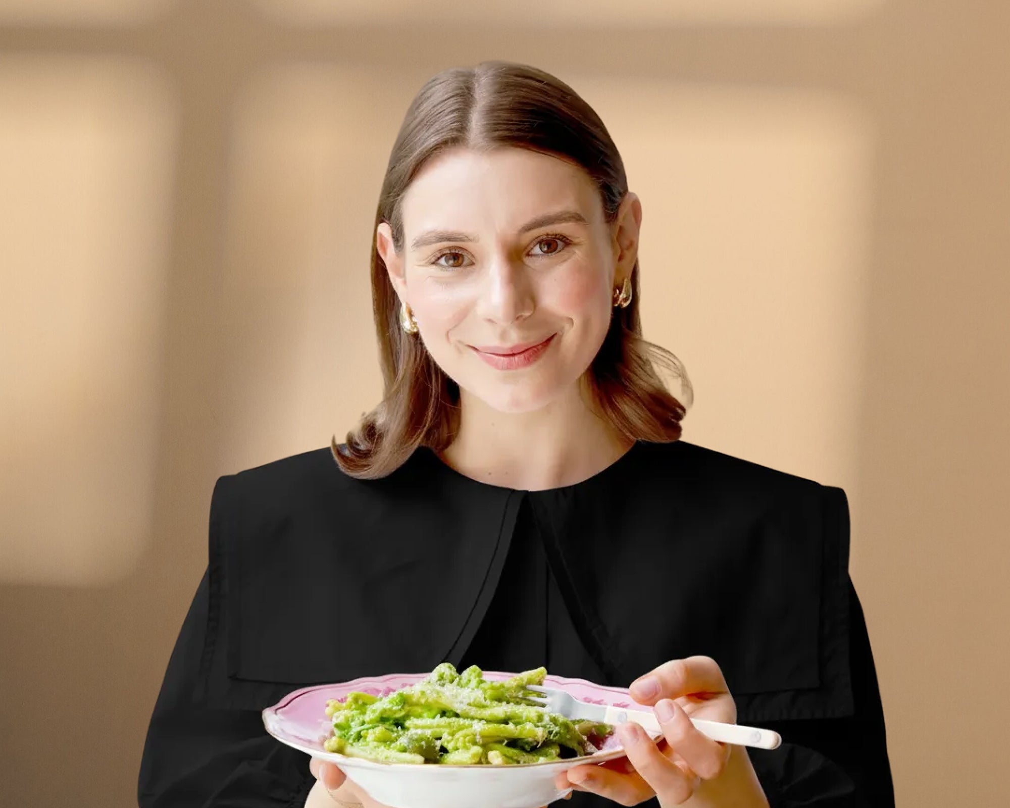 Mandy smiling holding a bowl of pasta