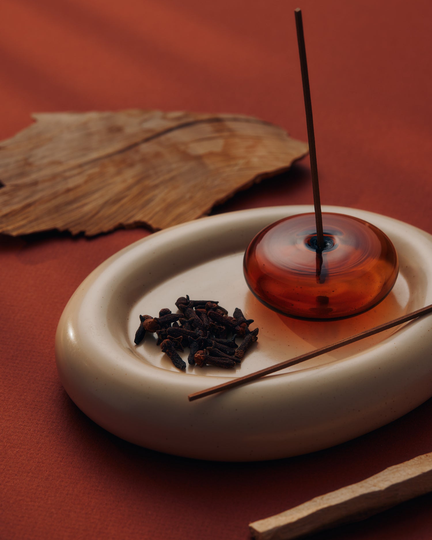 KIC Power incense burning in a bowl with cloves and cedarwood