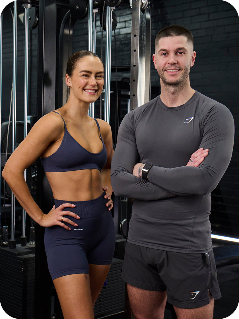 Two people in athletic wear standing in a gym setting