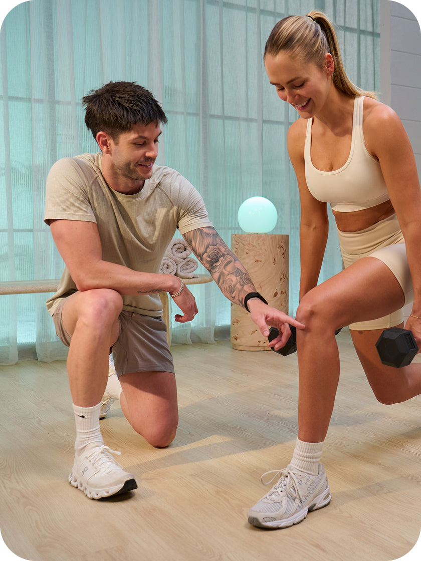 Two people exercising together in a modern indoor setting